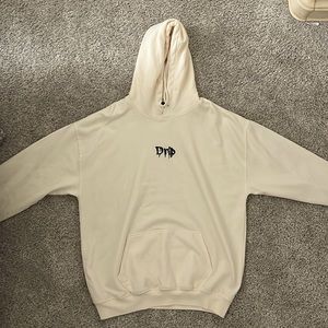 White/Cream colored “Drip” hoodie.